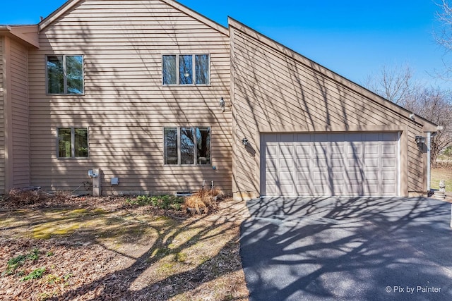 view of side of home featuring driveway