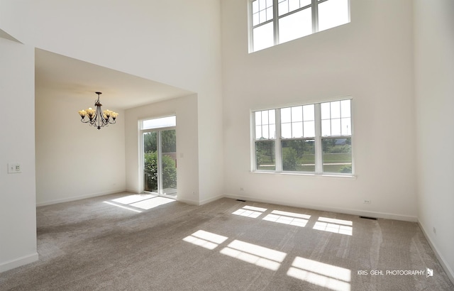 2850 Cattail Ct Unit C, Wauconda, IL 60084 - spare room featuring a chandelier, carpet flooring, and a high ceiling