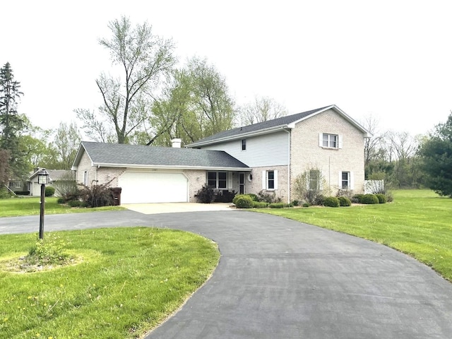 traditional home featuring brick siding, a garage, aphalt driveway, a front yard, and a chimney
