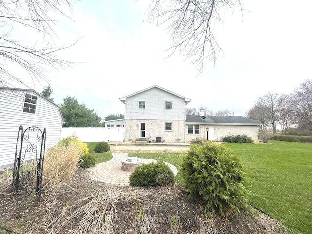 back of house featuring a lawn, a patio area, and fence