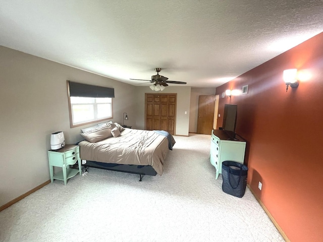 carpeted bedroom featuring baseboards and a ceiling fan