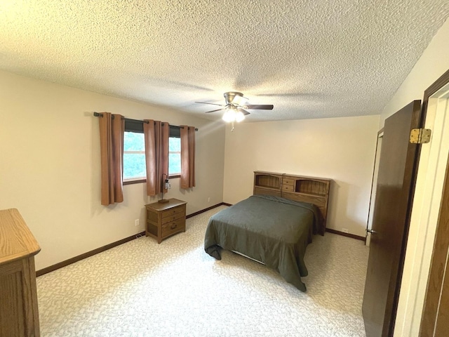 bedroom featuring baseboards, a textured ceiling, and ceiling fan