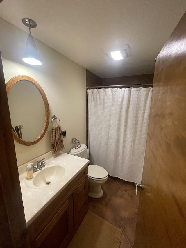 bathroom with vanity, lofted ceiling, toilet, tile patterned floors, and a shower with curtain