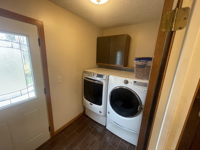 laundry area featuring laundry area, dark wood-style flooring, baseboards, washer and clothes dryer, and a textured ceiling