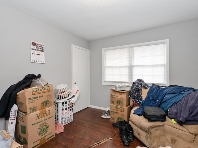 interior space with baseboards and wood finished floors