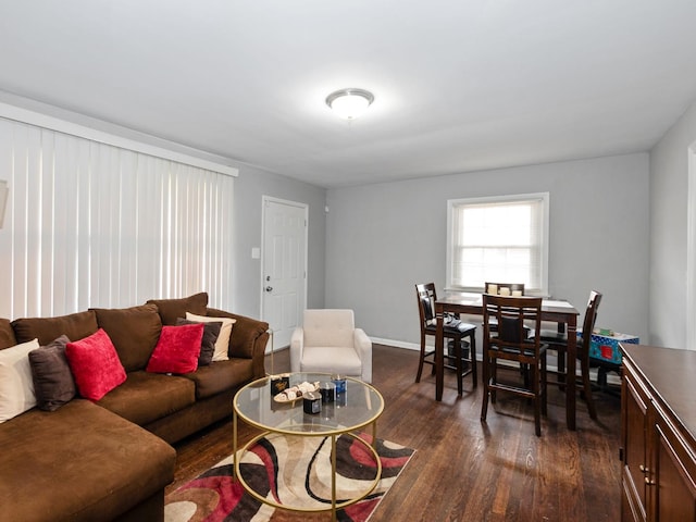 living room featuring baseboards and dark wood-style floors
