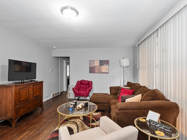 living area with dark wood-type flooring and visible vents