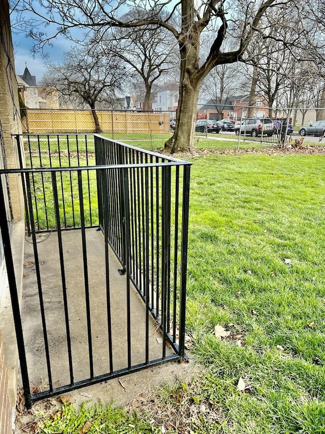 5424 W Ferdinand St Unit 104, Chicago, IL 60644 - view of gate featuring fence and a lawn