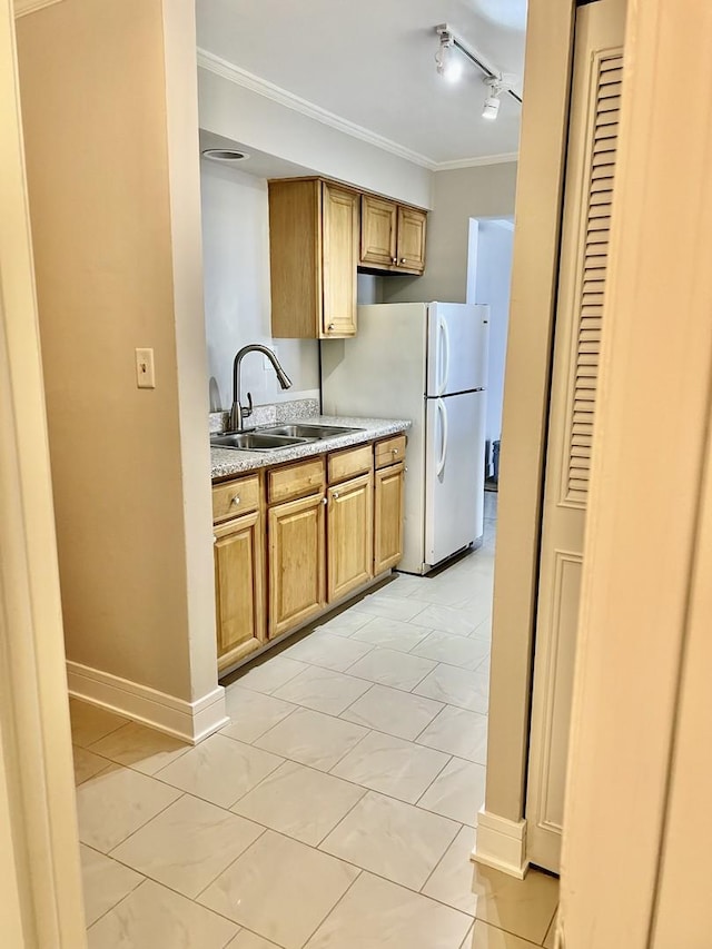 5424 W Ferdinand St Unit 104, Chicago, IL 60644 - kitchen with freestanding refrigerator, a sink, ornamental molding, and baseboards