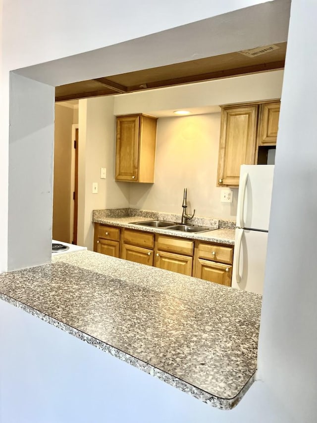 5424 W Ferdinand St Unit 104, Chicago, IL 60644 - kitchen with a sink, visible vents, freestanding refrigerator, and brown cabinets