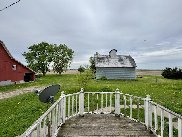wooden deck with an outbuilding, a barn, and a yard