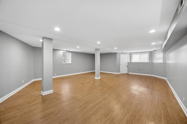 basement with recessed lighting, light wood-style floors, and baseboards
