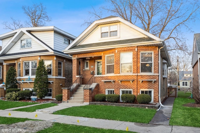 bungalow-style home with brick siding and a front lawn