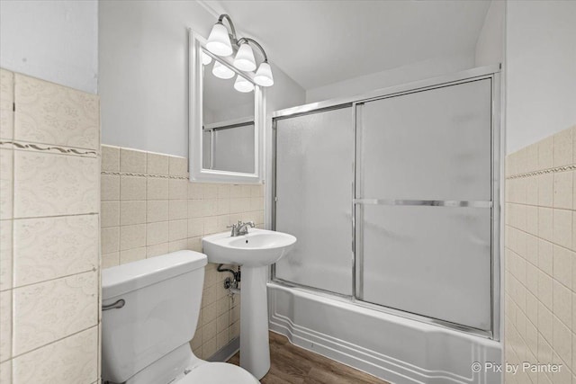 128 Adobe Cir, Carpentersville, IL 60110 - full bath featuring toilet, bath / shower combo with glass door, wood finished floors, and tile walls