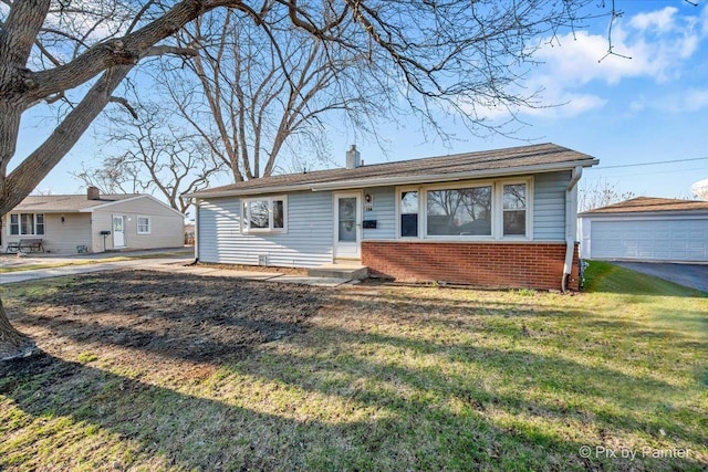 128 Adobe Cir, Carpentersville, IL 60110 - view of front of home featuring a front yard, an outbuilding, a garage, a chimney, and brick siding