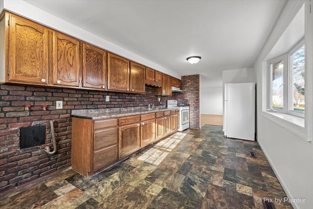 128 Adobe Cir, Carpentersville, IL 60110 - kitchen with white appliances, stone finish floor, visible vents, brown cabinets, and a sink