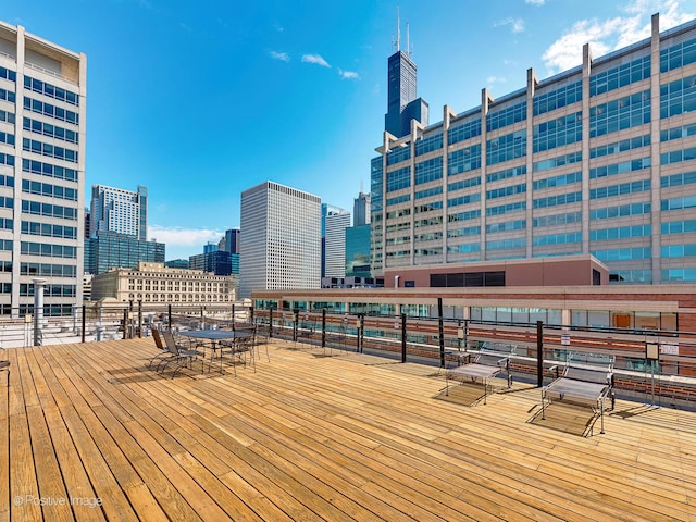 wooden terrace featuring a city view