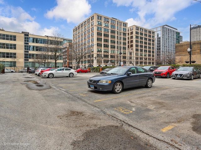 view of building exterior with uncovered parking