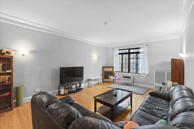 living area featuring crown molding, an AC wall unit, baseboards, and light wood-style floors