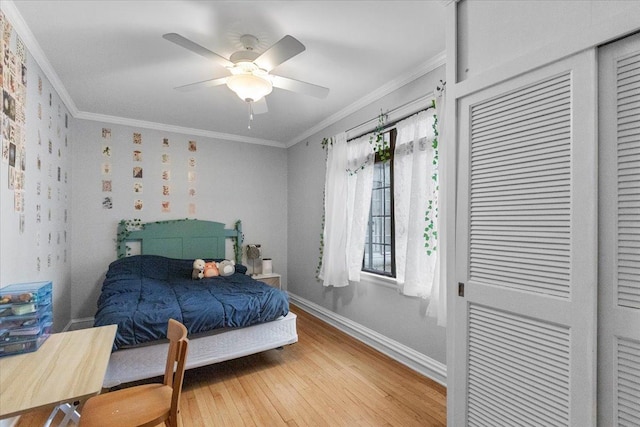 bedroom with ornamental molding, light wood-style flooring, a ceiling fan, and baseboards