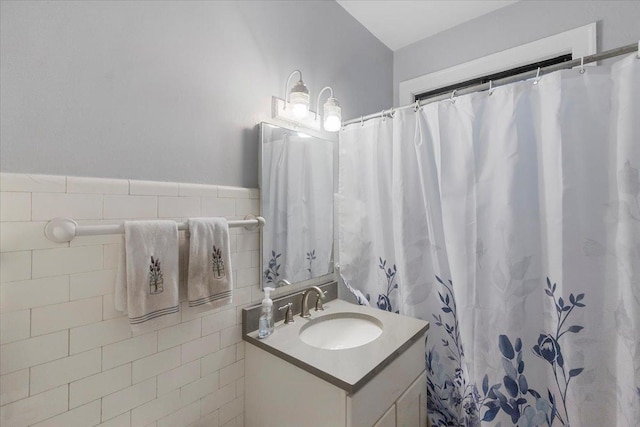 bathroom with vanity, tile walls, and a shower with curtain