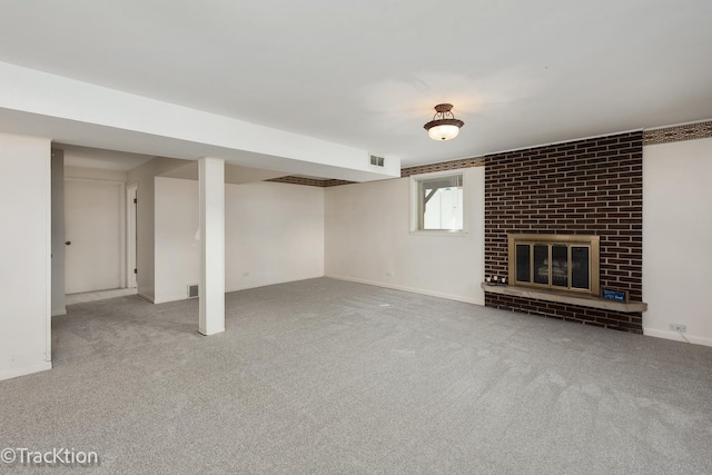 basement featuring carpet, a brick fireplace, and baseboards