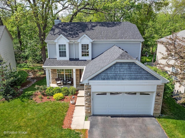 14 Wildflower Way, Streamwood, IL 60107 - traditional-style house with stone siding, roof with shingles, a chimney, driveway, and a front lawn