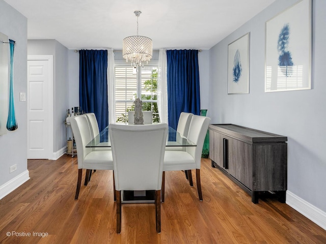 14 Wildflower Way, Streamwood, IL 60107 - dining area with baseboards, a chandelier, and wood finished floors