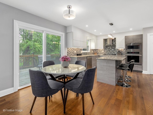 14 Wildflower Way, Streamwood, IL 60107 - dining room featuring dark wood-style flooring and baseboards