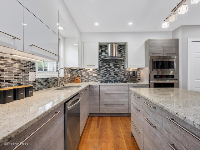 14 Wildflower Way, Streamwood, IL 60107 - kitchen with stainless steel appliances, wall chimney exhaust hood, a sink, modern cabinets, and decorative backsplash