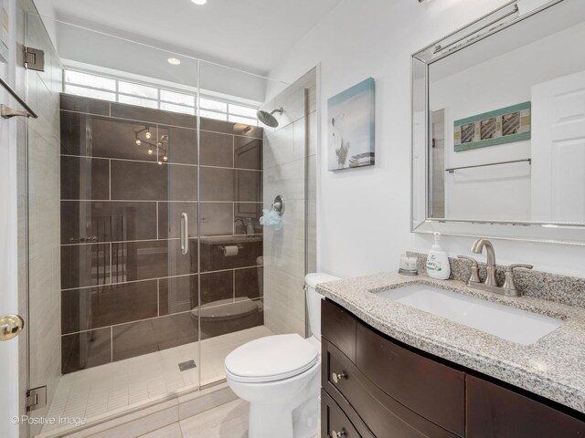 14 Wildflower Way, Streamwood, IL 60107 - bathroom featuring toilet, a stall shower, vanity, and tile patterned floors
