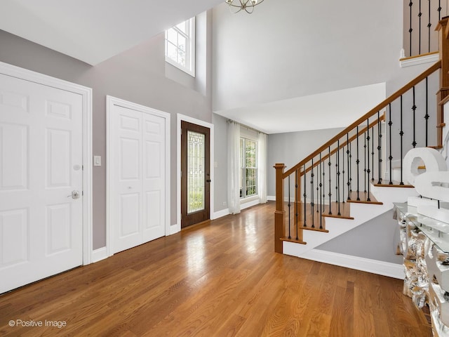 14 Wildflower Way, Streamwood, IL 60107 - foyer featuring stairway, wood finished floors, a high ceiling, and baseboards