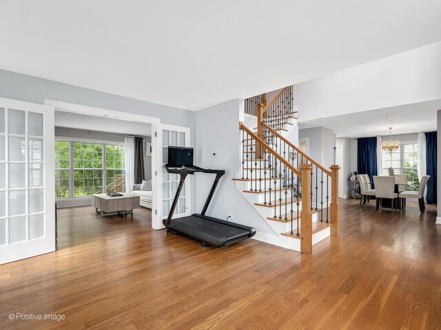 14 Wildflower Way, Streamwood, IL 60107 - workout area with healthy amount of natural light, wood finished floors, and a chandelier