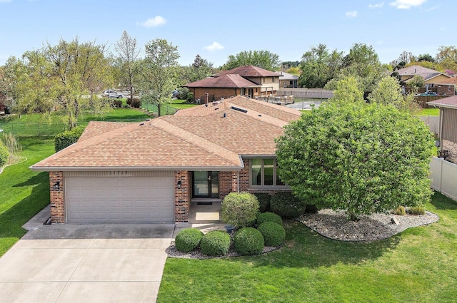 view of front facade featuring an attached garage, roof with shingles, driveway, and brick siding
