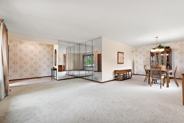 interior space with an inviting chandelier, baseboards, and wallpapered walls