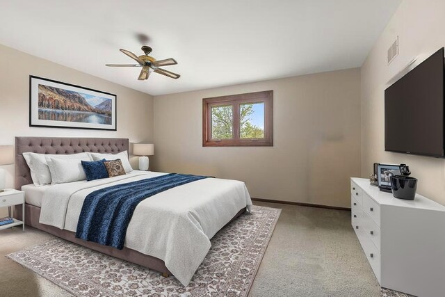 bedroom with visible vents, baseboards, ceiling fan, and light colored carpet