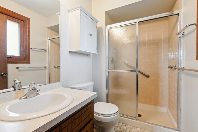 full bathroom with vanity, a stall shower, and toilet