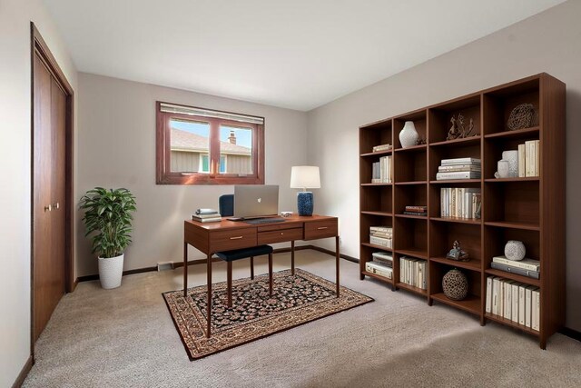 office area with baseboards and light carpet