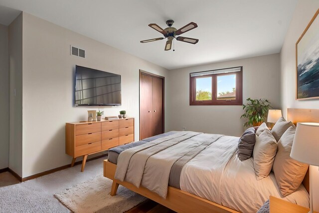 bedroom with light colored carpet, a ceiling fan, baseboards, visible vents, and a closet