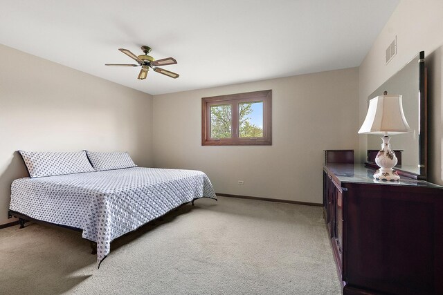 bedroom with visible vents, a ceiling fan, baseboards, and light colored carpet
