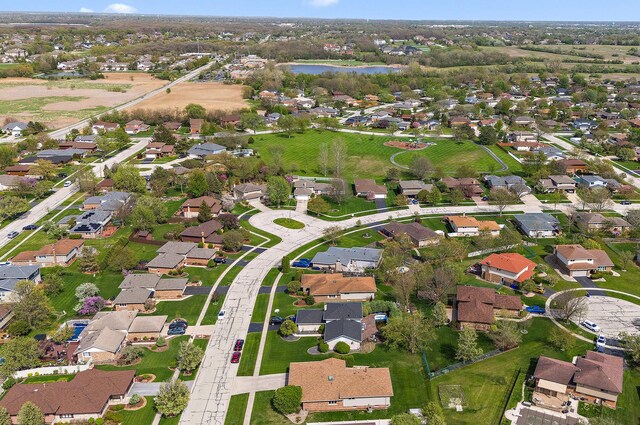 drone / aerial view with a water view and a residential view