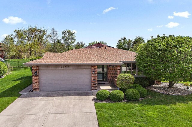 ranch-style house with a front yard, a garage, brick siding, concrete driveway, and a shingled roof