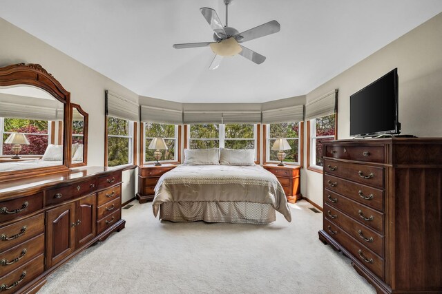 bedroom featuring light colored carpet, multiple windows, and ceiling fan