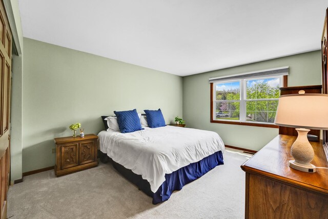 bedroom with baseboards and carpet floors