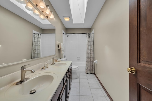 bathroom with tile patterned floors, toilet, a skylight, double vanity, and shower / tub combo with curtain