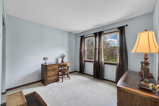 home office with light colored carpet and baseboards