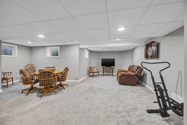 dining room featuring carpet floors, baseboards, and a drop ceiling