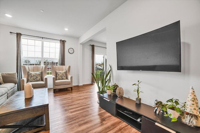 living room featuring recessed lighting, wood finished floors, and a healthy amount of sunlight