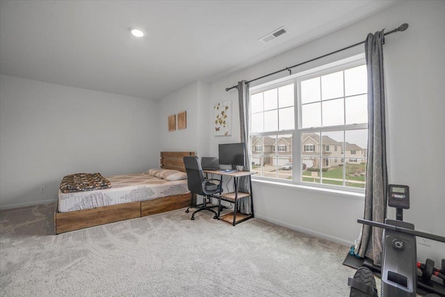 carpeted bedroom with baseboards and visible vents