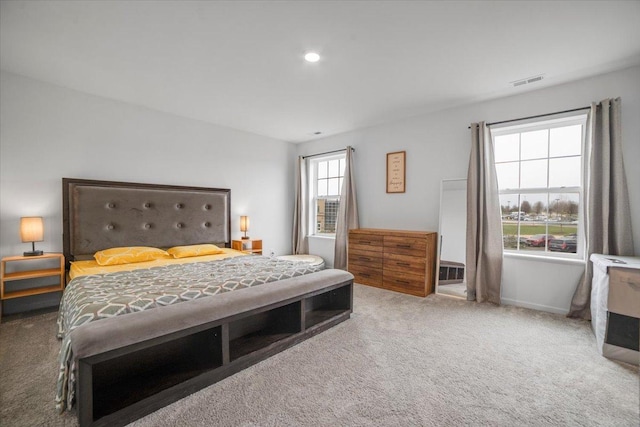 bedroom with baseboards, carpet, and visible vents
